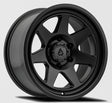 Black alloy wheel with a visible brand logo on a gray background