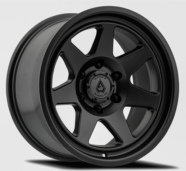 Black alloy wheel with a visible brand logo on a gray background