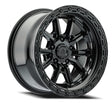 Black alloy wheel with a detailed rim design on a white background