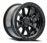 Black alloy wheel with a detailed rim design on a white background