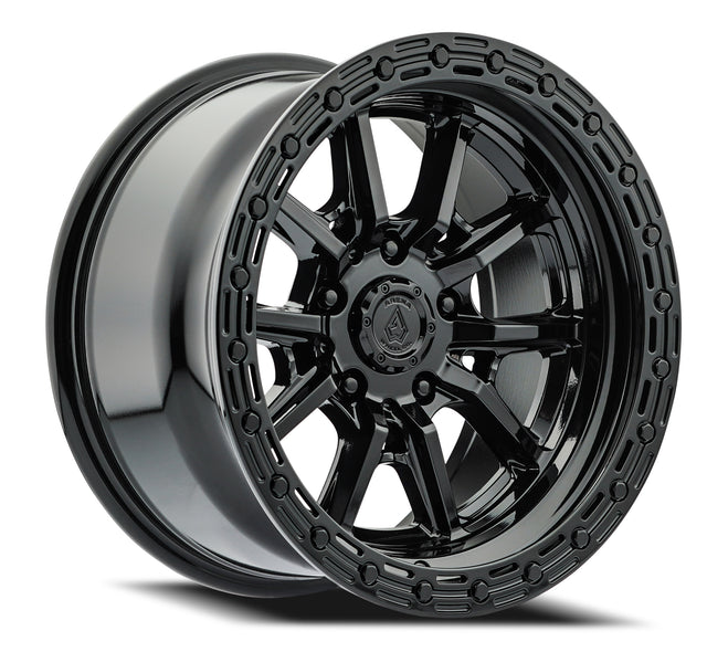 Black alloy wheel with a detailed rim design on a white background