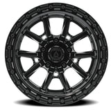 Black alloy wheel with a detailed rim design on a white background