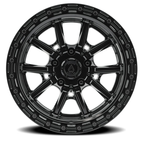 Black alloy wheel with a detailed rim design on a white background