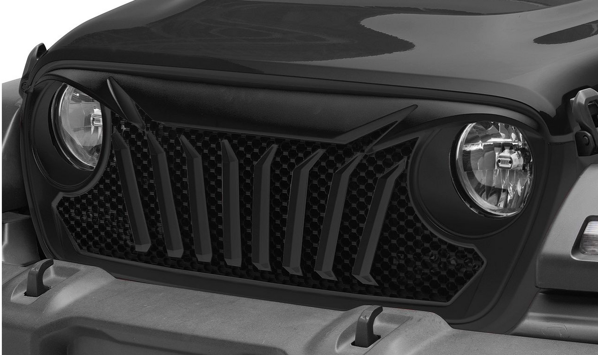 Close-up of a vehicle's grille and headlights with a black finish.